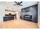 Modern living room with sleek electric fireplace, open layout, and hardwood floors at 606 E Dry Creek Pl, Littleton, CO 80122