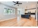 Spacious open concept living space featuring hardwood floors, large windows, and modern kitchen with granite island at 606 E Dry Creek Pl, Littleton, CO 80122