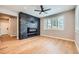 Modern living room featuring hardwood floors, stone fireplace and sunny windows at 606 E Dry Creek Pl, Littleton, CO 80122