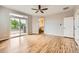 A spacious main bedroom with light wood flooring, ceiling fan, walk out to balcony, and en suite bath at 606 E Dry Creek Pl, Littleton, CO 80122
