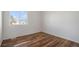 The bright bedroom has hardwood floors and a window letting in natural light at 1965 E 127Th Cir, Thornton, CO 80241