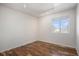 Bright bedroom features hardwood floors, a window for natural light, and modern track lighting at 1965 E 127Th Cir, Thornton, CO 80241