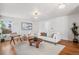 Bright living room with hardwood floors, neutral decor, and stylish furniture; bathed in natural light at 1965 E 127Th Cir, Thornton, CO 80241