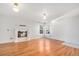 Bright living room with hardwood floors, white walls, a charming fireplace, and ample natural light at 1965 E 127Th Cir, Thornton, CO 80241