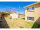 The backyard features a storage shed, wood fence and green grass at 1085 Kingston St, Aurora, CO 80010