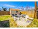 Backyard patio features a table and chairs with a storage shed and privacy fence at 1085 Kingston St, Aurora, CO 80010
