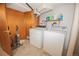 Practical laundry area equipped with a washer, dryer, storage shelves, and utility cleaning supplies at 1085 Kingston St, Aurora, CO 80010