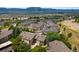 Expansive aerial view of community showcasing mature trees, manicured lawns, and prime location near local amenities at 1140 Magic Lamp Way # 4, Monument, CO 80132