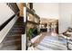 Spacious living room with stone fireplace, staircase and kitchen view at 1140 Magic Lamp Way # 4, Monument, CO 80132