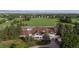 Aerial view of the clubhouse featuring a golf course, trees, and distant mountain views at 882 Eldorado Dr, Superior, CO 80027