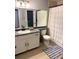 Bathroom with a tub and shower combination, a vanity with a sink, and a mirror at 8787 W Cornell Ave # 6, Lakewood, CO 80227