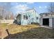 View of home's backyard with partial view of home's exterior, shed, lawn chair and wooden fence at 1625 19Th Ave, Longmont, CO 80501