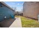 Backyard of home featuring grass, concrete patio, and a wooden fence in the background with a blue lawn chair at 1625 19Th Ave, Longmont, CO 80501