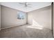 Spacious bedroom with neutral carpet, a ceiling fan, and a bright window at 1625 19Th Ave, Longmont, CO 80501