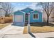 Charming blue single-story home featuring a front lawn, attached garage, and inviting front entrance at 1625 19Th Ave, Longmont, CO 80501