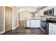 Bright kitchen boasts stainless steel appliances, white cabinetry, and modern finishes at 1625 19Th Ave, Longmont, CO 80501