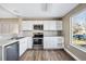 Bright kitchen featuring white cabinetry, tile backsplash, stainless steel appliances, and natural light at 1625 19Th Ave, Longmont, CO 80501