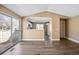 Open living space with wood-look floors flowing into the kitchen featuring white cabinets and stainless appliances at 1625 19Th Ave, Longmont, CO 80501