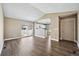 Open concept living area with hardwood floors flowing into the adjacent kitchen with white cabinetry at 1625 19Th Ave, Longmont, CO 80501