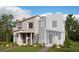 Modern townhome with brick and siding exterior, front porch, and well-manicured landscaping at 24118 E Warm Springs Ave, Aurora, CO 80019