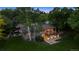 Aerial view of the home, highlighting the deck, stone patio, and mature landscaping at 5653 E Southmoor Cir, Englewood, CO 80111