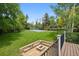 Backyard view with a fire pit and a sports court in the distance at 5653 E Southmoor Cir, Englewood, CO 80111