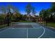 Lovely backyard featuring a basketball court and meticulously kept lawn with trees at 5653 E Southmoor Cir, Englewood, CO 80111