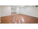Spacious finished basement featuring hardwood flooring, a mirrored wall and natural light at 5653 E Southmoor Cir, Englewood, CO 80111