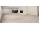 Finished basement with fireplace, neutral carpet, and ample space for entertaining at 5653 E Southmoor Cir, Englewood, CO 80111