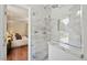 Modern bathroom boasts a glass-enclosed shower with marble tile and backyard view at 5653 E Southmoor Cir, Englewood, CO 80111