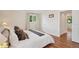 Comfortable bedroom features wood floors, a window with natural light, and neutral-toned decor at 5653 E Southmoor Cir, Englewood, CO 80111