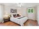 Comfortable bedroom features hardwood floors, a window with natural light, and neutral-toned decor at 5653 E Southmoor Cir, Englewood, CO 80111