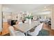 Open-concept dining area with hardwood flooring, a large table, and seamless access to the kitchen and living spaces at 5653 E Southmoor Cir, Englewood, CO 80111