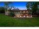 Exterior shot of a home with a walkout basement, stone patio, and second story deck at 5653 E Southmoor Cir, Englewood, CO 80111