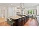 Eat-in kitchen features island with cooktop, custom cabinets, and stainless steel appliances at 5653 E Southmoor Cir, Englewood, CO 80111