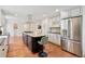 Bright eat-in kitchen features custom cabinets, stainless steel appliances, and hardwood floors at 5653 E Southmoor Cir, Englewood, CO 80111