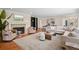 Comfortable living room features a stone fireplace, hardwood floors, and a large area rug, perfect for relaxing at 5653 E Southmoor Cir, Englewood, CO 80111
