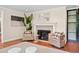 Charming living room with a decorative fireplace, hardwood flooring, and stylish seating, creating a cozy ambiance at 5653 E Southmoor Cir, Englewood, CO 80111