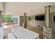 Outdoor living space with a tv, dining set, and stone pillars at 5653 E Southmoor Cir, Englewood, CO 80111