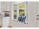 Eat-in kitchen features window seat, custom cabinets, and backyard view at 5653 E Southmoor Cir, Englewood, CO 80111