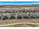 An aerial view of several tan two-story homes with landscaped yards in a suburban neighborhood at 7851 E 148Th Dr, Thornton, CO 80602