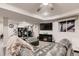 Finished basement with comfortable seating area, bar, and entertainment center with an electric fireplace at 7851 E 148Th Dr, Thornton, CO 80602