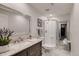Bathroom featuring marble countertops and flooring, a vanity, toilet, and glass-enclosed shower at 7851 E 148Th Dr, Thornton, CO 80602
