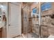 Modern bathroom featuring a tiled shower with glass door and tiled walls at 7851 E 148Th Dr, Thornton, CO 80602