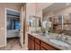 Bathroom featuring double sinks with granite countertops and a separate tiled shower at 7851 E 148Th Dr, Thornton, CO 80602