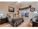 Cozy bedroom with carpet, a large window with backyard views and stylish decor at 7851 E 148Th Dr, Thornton, CO 80602