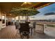 Covered deck with outdoor dining set and golf course views at 7851 E 148Th Dr, Thornton, CO 80602