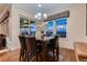 Dining room featuring a wooden table with seating, a chandelier, and lots of natural light at 7851 E 148Th Dr, Thornton, CO 80602