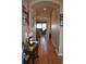 Inviting hallway featuring an archway and hardwood floors, creating a warm and welcoming entrance at 7851 E 148Th Dr, Thornton, CO 80602