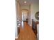 Open hallway with gleaming hardwood floors, neutral walls, and an arched doorway entrance at 7851 E 148Th Dr, Thornton, CO 80602